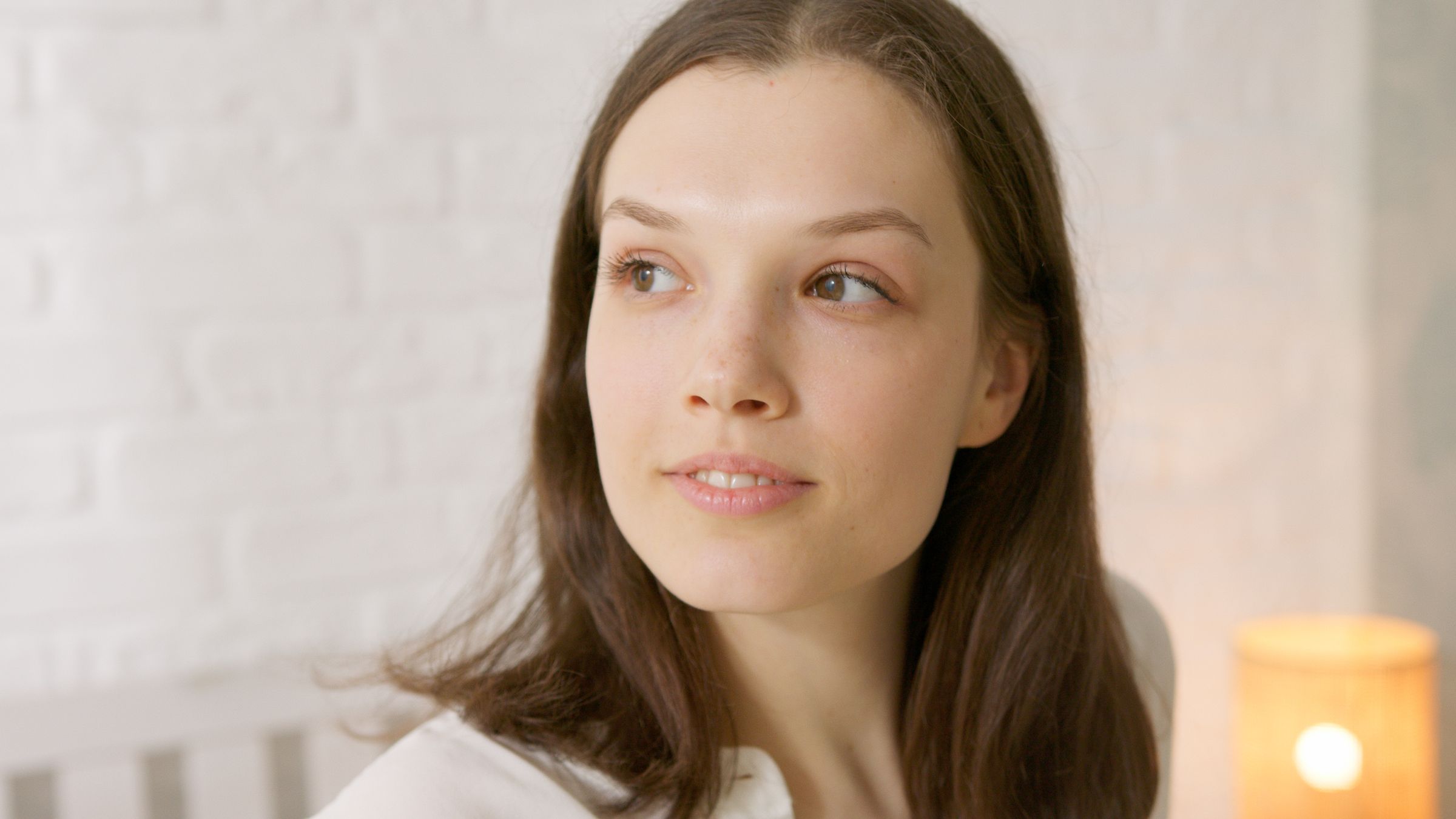Extreme close-up of a woman’s eyes and upper cheeks in soft daylight